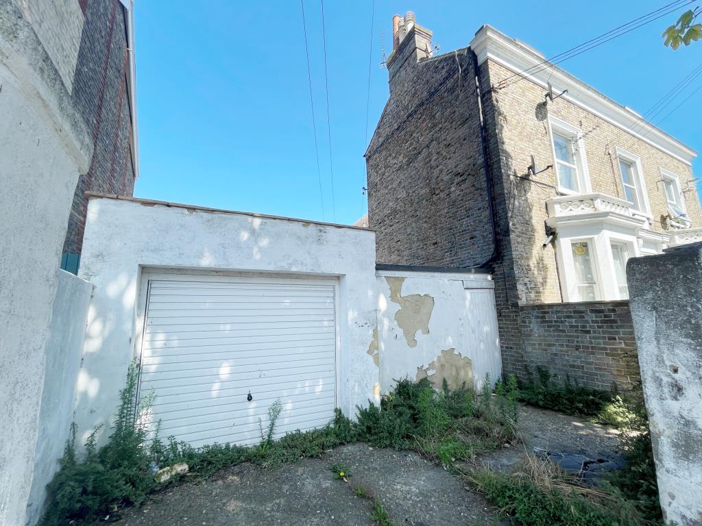 Lot: 72 - MIXED USE INVESTMENT - TWO SHOPS, FOUR FLATS AND GARAGE WITH POTENTIAL - Garage with forecourt